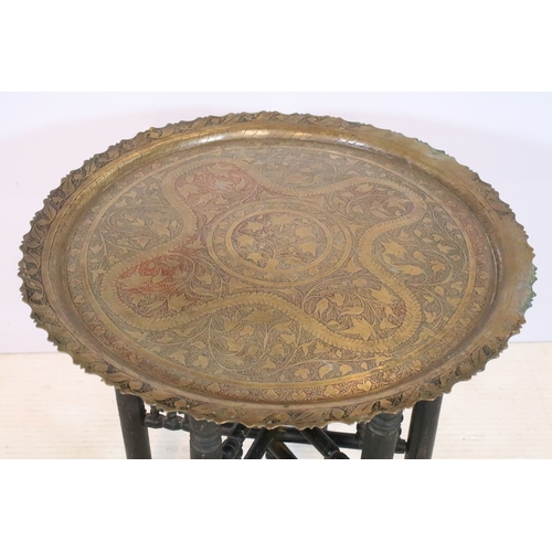566 - Early 20th century brass topped Benares table, having tray top with incised and colour filled decora... 