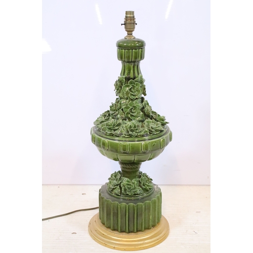 576 - 20th century pottery baluster lamp base, in green glaze with relief work flora, raised on a fluted b... 
