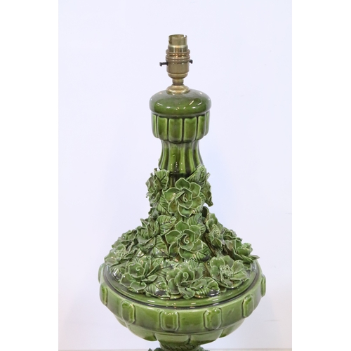 576 - 20th century pottery baluster lamp base, in green glaze with relief work flora, raised on a fluted b... 