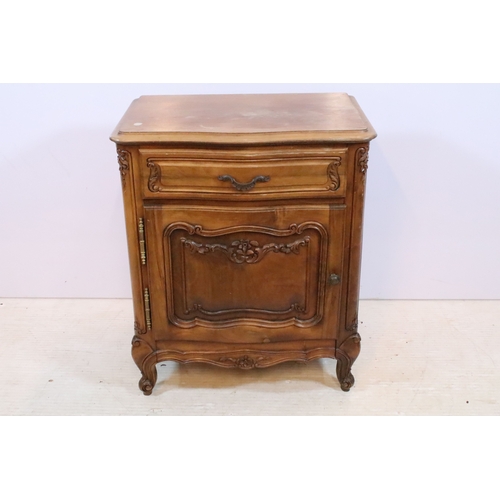 601 - 20th century French-style walnut bedside cabinet, having heavily moulded decoration to door and feet... 