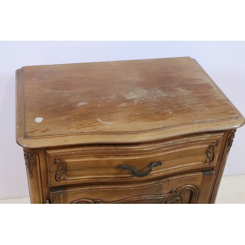 601 - 20th century French-style walnut bedside cabinet, having heavily moulded decoration to door and feet... 