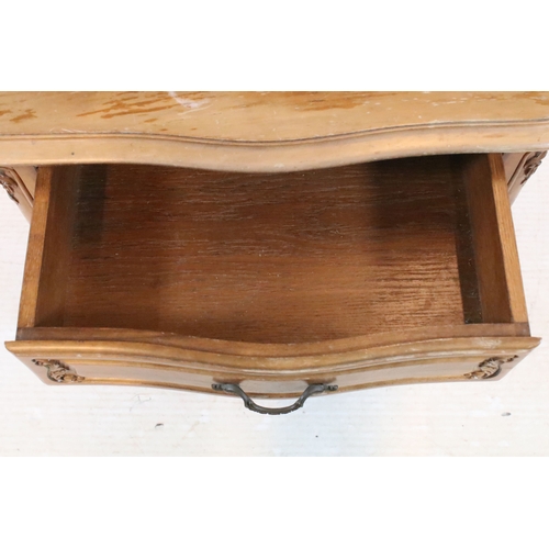 601 - 20th century French-style walnut bedside cabinet, having heavily moulded decoration to door and feet... 