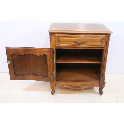 601 - 20th century French-style walnut bedside cabinet, having heavily moulded decoration to door and feet... 