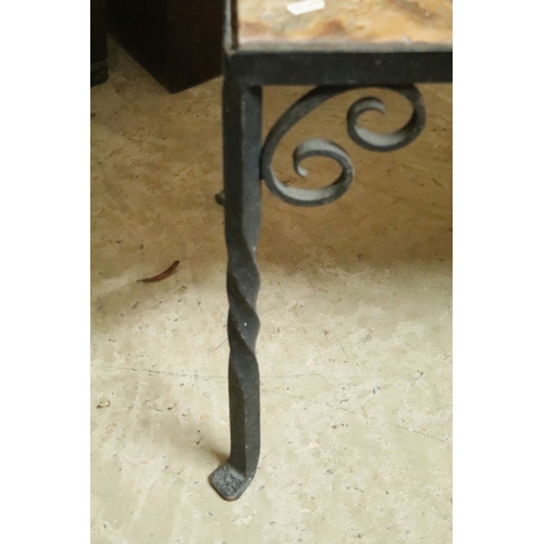 609 - Wrought metal and onyx topped coffee table, having stone inset to the top, raised on twisted legs wi... 