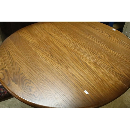 616 - Ercol pedestal extending dining table, having oval top with baluster stem base and swept legs, 110cm... 