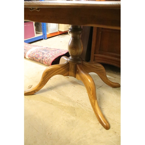 616 - Ercol pedestal extending dining table, having oval top with baluster stem base and swept legs, 110cm... 