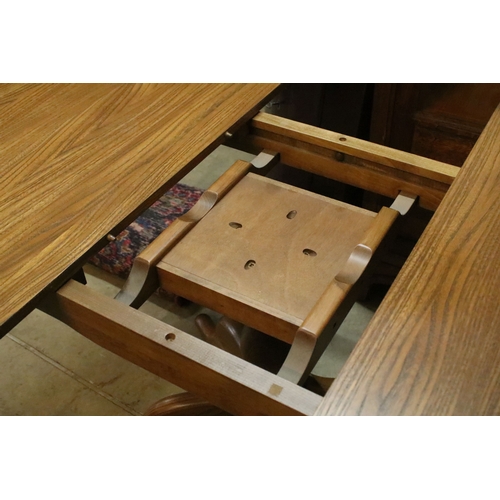 616 - Ercol pedestal extending dining table, having oval top with baluster stem base and swept legs, 110cm... 