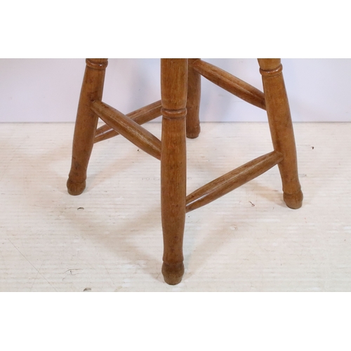 627 - 20th century vintage oak and elm kitchen stool, having round top on turned legs, W 37cm x H 58cm