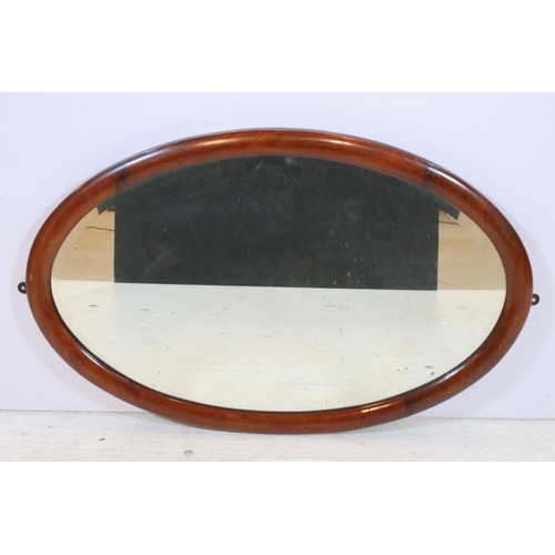 630 - Edwardian mahogany framed wall mirror, having an oval bevelled plate, 72cm x 46cm