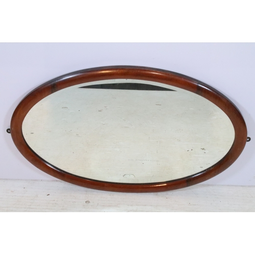 630 - Edwardian mahogany framed wall mirror, having an oval bevelled plate, 72cm x 46cm