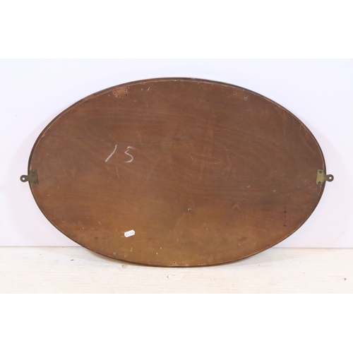 630 - Edwardian mahogany framed wall mirror, having an oval bevelled plate, 72cm x 46cm