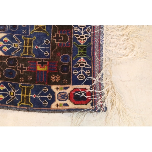 580 - Turkish blue ground rug, having geometric border with colourful accents, 107cm x 206cm