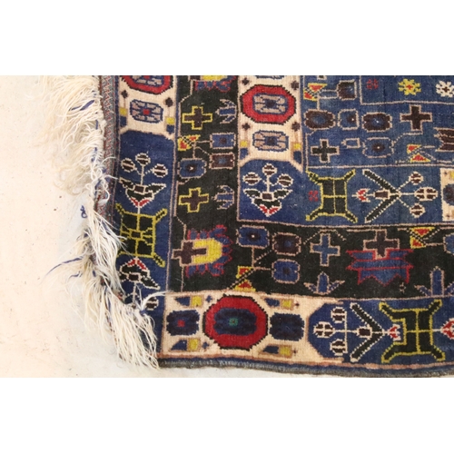 580 - Turkish blue ground rug, having geometric border with colourful accents, 107cm x 206cm