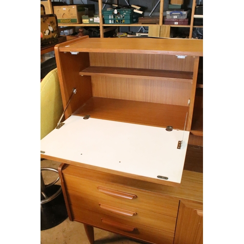 639 - Mid 20th century teak veneered sideboard, having a high back with cupboard upon three drawers, W 129... 