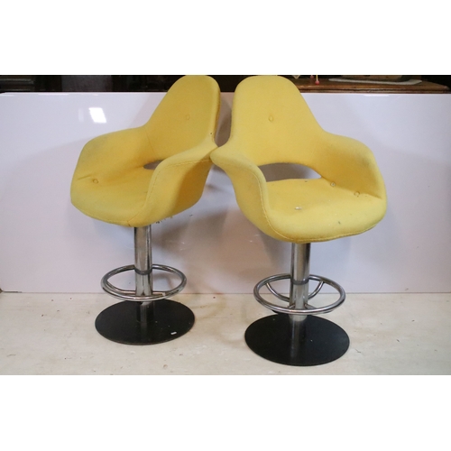 642 - Pair of 20th century egg stools, having yellow buttoned upholstery, raised on chromed stem with foot... 