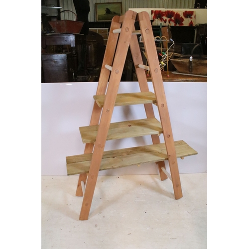 646 - Wooden part painted ladder display shelf, the hinged ladders holding three graduated pine shelves, 1... 
