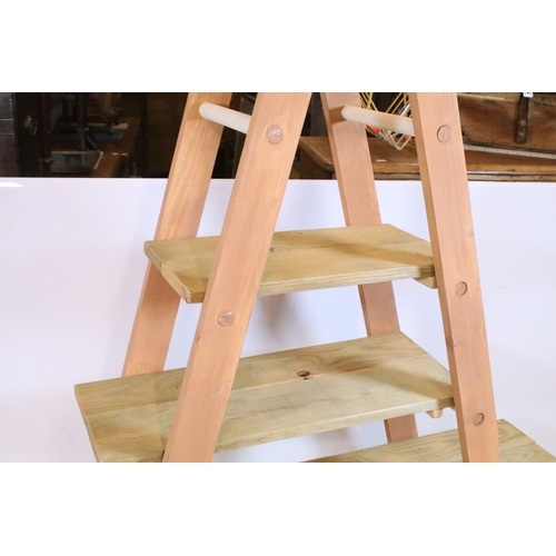 646 - Wooden part painted ladder display shelf, the hinged ladders holding three graduated pine shelves, 1... 