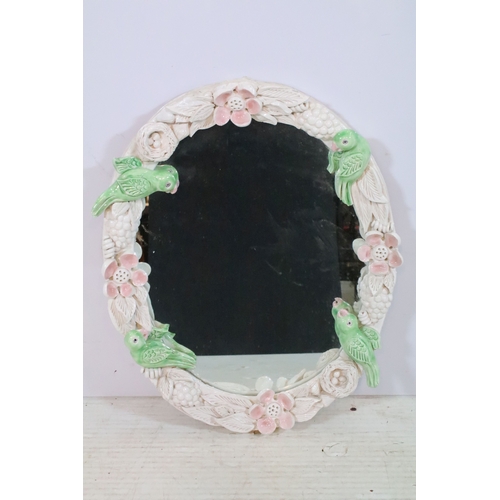 666 - Contemporary pottery framed wall mirror, having birds and foliage to the surround, 60cm x 49cm