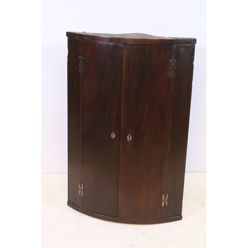 667 - 19th century mahogany bow fronted corner cupboard, having inlaid doors, W 55cm x H 92cm