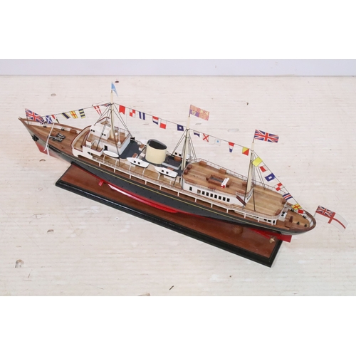 389 - Model ship replica of HMS Royal Yacht Britannia raised on wooden plinth, L 72cm x H 32cm (approx.)
