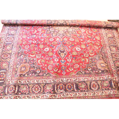 623 - Persian hand-knotted rug, of large proportions, on red and deep blue ground, 301 x 376cm