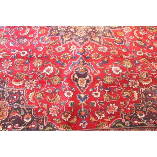 623 - Persian hand-knotted rug, of large proportions, on red and deep blue ground, 301 x 376cm