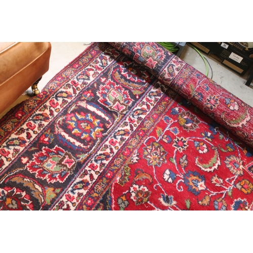 623 - Persian hand-knotted rug, of large proportions, on red and deep blue ground, 301 x 376cm