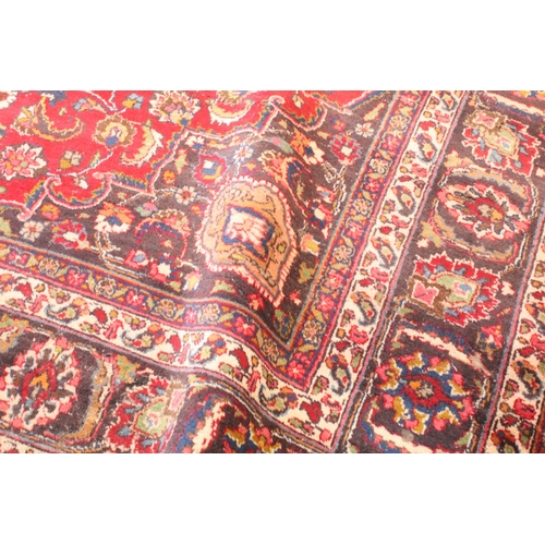 623 - Persian hand-knotted rug, of large proportions, on red and deep blue ground, 301 x 376cm