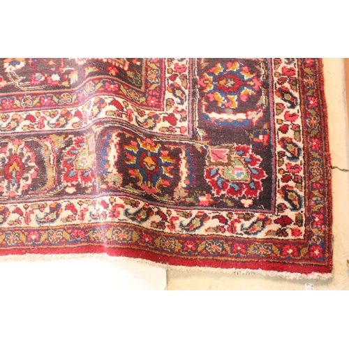 623 - Persian hand-knotted rug, of large proportions, on red and deep blue ground, 301 x 376cm