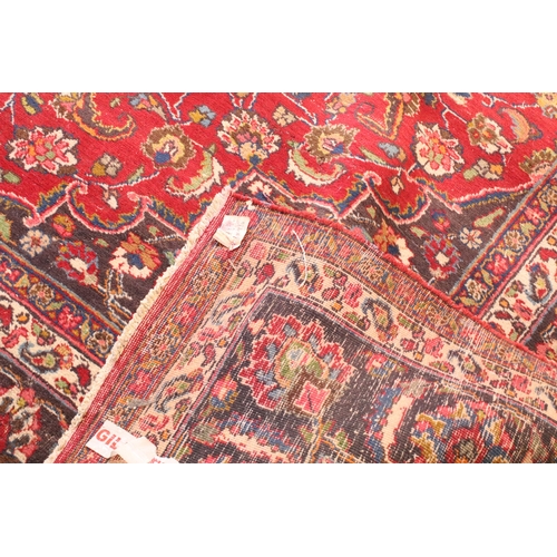 623 - Persian hand-knotted rug, of large proportions, on red and deep blue ground, 301 x 376cm