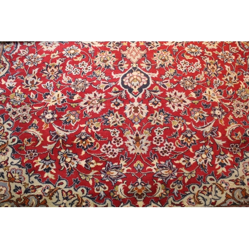 640 - Persian Isfahan rug, of large proportions, of red ground with intertwining swags, within blue border... 