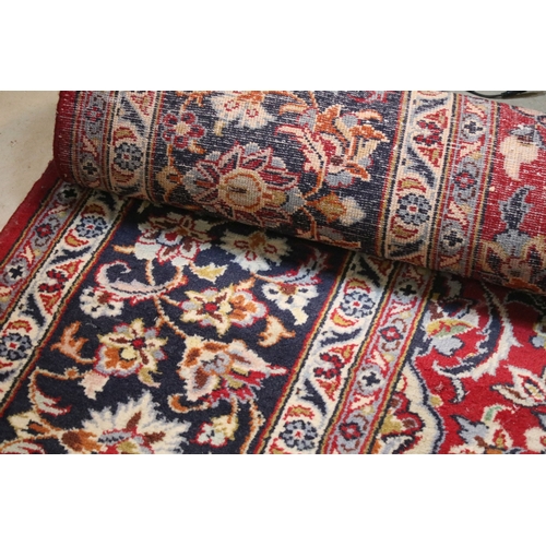 640 - Persian Isfahan rug, of large proportions, of red ground with intertwining swags, within blue border... 