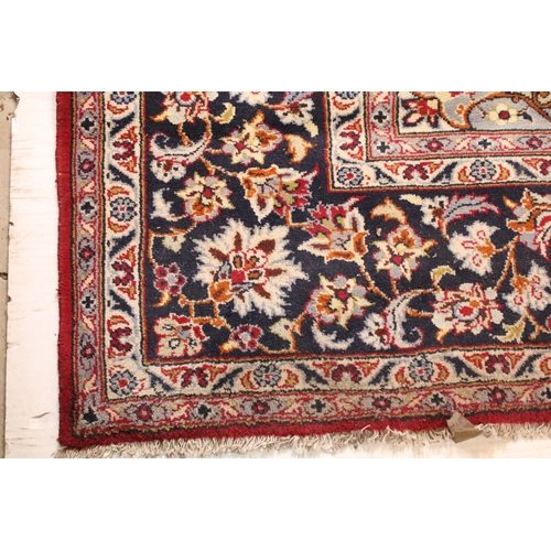 640 - Persian Isfahan rug, of large proportions, of red ground with intertwining swags, within blue border... 