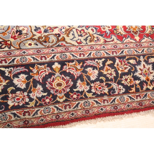 640 - Persian Isfahan rug, of large proportions, of red ground with intertwining swags, within blue border... 