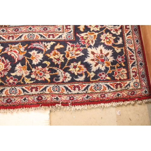 640 - Persian Isfahan rug, of large proportions, of red ground with intertwining swags, within blue border... 