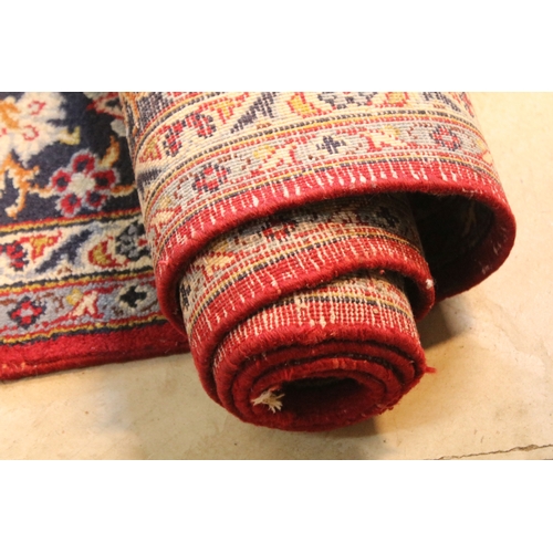 640 - Persian Isfahan rug, of large proportions, of red ground with intertwining swags, within blue border... 