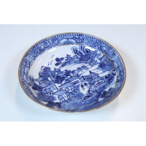 5 - Pair of Chinese blue and white tea bowls and saucers, decorated finely with pagodas and willows, gil... 