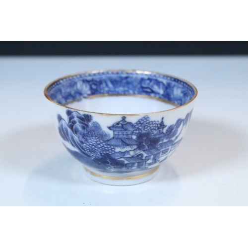 5 - Pair of Chinese blue and white tea bowls and saucers, decorated finely with pagodas and willows, gil... 