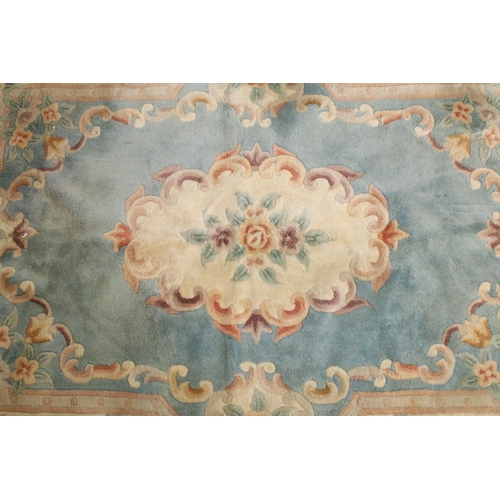 611 - 20th century Chinese-style rug, having blue ground with central medallion within floral border