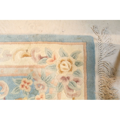 611 - 20th century Chinese-style rug, having blue ground with central medallion within floral border