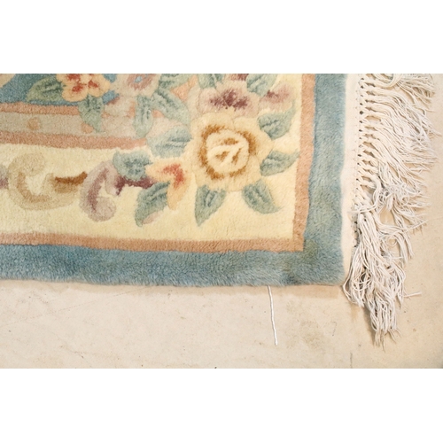 611 - 20th century Chinese-style rug, having blue ground with central medallion within floral border