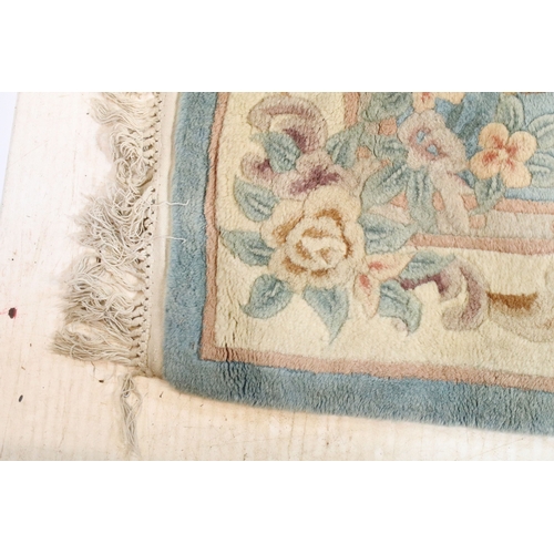 611 - 20th century Chinese-style rug, having blue ground with central medallion within floral border