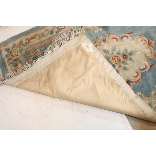 611 - 20th century Chinese-style rug, having blue ground with central medallion within floral border