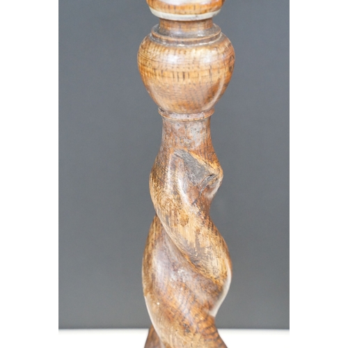 124 - Pair of early 20th century turned oak barley twist candle sticks with circular bases and ornate bras... 