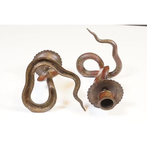 138 - Pair of coiled cobra candlesticks, H 15cm together with a small Indian brass vase, H 9cm (3)