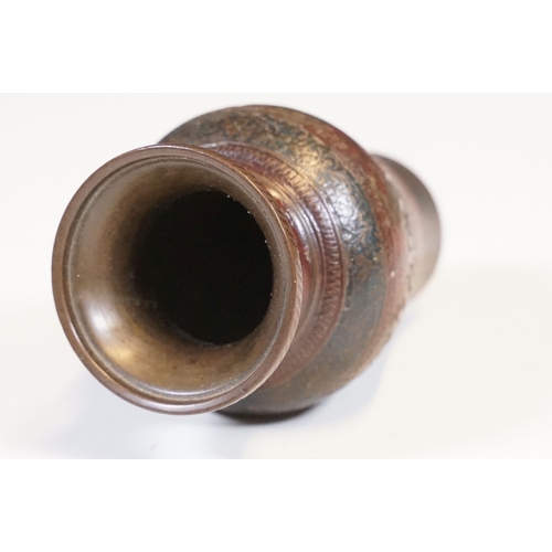 138 - Pair of coiled cobra candlesticks, H 15cm together with a small Indian brass vase, H 9cm (3)