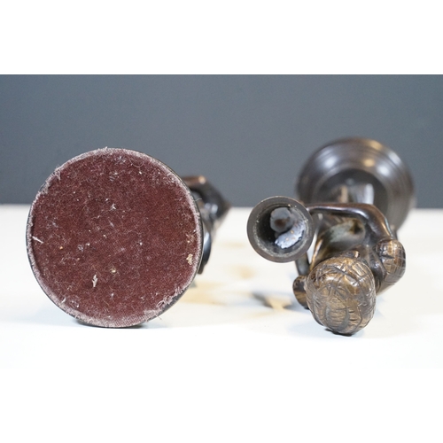 144 - Pair of Indian bronze candelabra candle holders depicting figures holding torches raised on circular... 