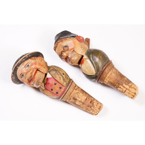 180 - Two vintage novelty folk art carved wooden and cork figural wine bottle stoppers, probably German