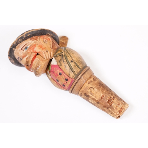 180 - Two vintage novelty folk art carved wooden and cork figural wine bottle stoppers, probably German