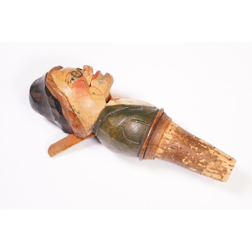 180 - Two vintage novelty folk art carved wooden and cork figural wine bottle stoppers, probably German